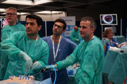 Course attendees observing live surgery